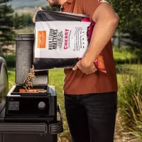 2026/10/traeger-2024-cherry-pellets-lifestyle-pour.webp